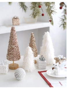 Detailed close-up of decorative mini Christmas trees with champagne gold sequins and pearls