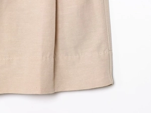 Detail of khaki linen shorts showing high-quality twill fabric texture and stitching