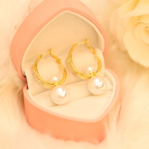 Elegant gold pearl drop earrings in a pink heart jewelry box with white rose detail