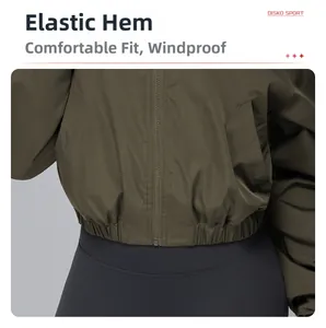 Close-up of the elastic hem design on a dark olive green windproof sports jacket