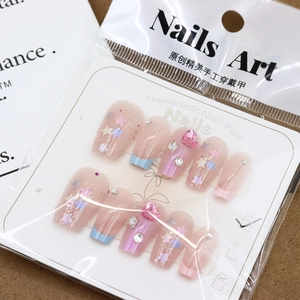 Pink press-on nails with colorful star sequins, rhinestones, and resin hearts in M size