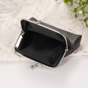 Black PU leather skull coin purse with silver metal clasp closure on white knit background