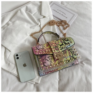 Detail of transparent PVC jelly bag with colorful graffiti patterns and gold chain strap