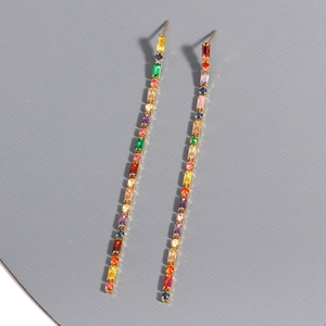 Macro shot of colorful rectangular cubic zirconia linear drop earrings with gold plating