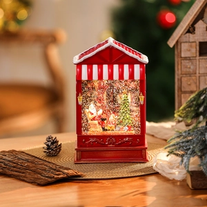 Detailed view of a lit Christmas snow globe featuring Santa and a tree on a woven mat