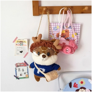 Detail of plush squirrel bag with blue sweater and reindeer headband on a gold chain