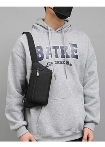 Close-up of durable black multi-functional waist bag with multiple zippers and nylon texture