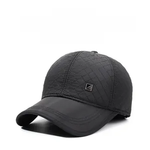 Close-up of black quilted winter baseball cap with ear flaps and metal buckle detail