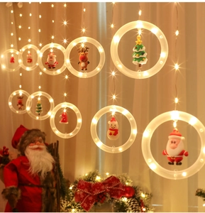 Detail of warm white LED ring curtain lights featuring Santa Claus and snowman dolls