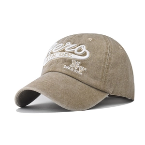 Detail of vintage washed khaki baseball cap with high-density embroidery and distressed texture