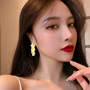Elegant yellow flower drop earrings for women with a matte finish on model