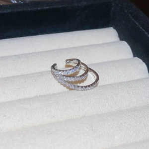 Macro shot of silver-tone triple-layer ear cuff featuring rows of sparkling cubic zirconia