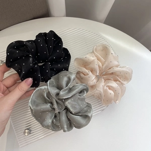 Three elegant satin scrunchies with rhinestones in black, silver, and champagne colors