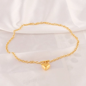 Polished 18k gold heart pendant necklace with toggle clasp on elegant white silk