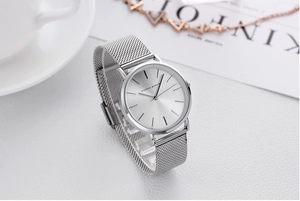 Silver ladies mesh watch with white coffee cup and magazine for stylish lifestyle