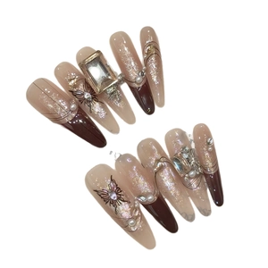 Long stiletto press-on nails with butterfly art, 3D rhinestones and pearl accents