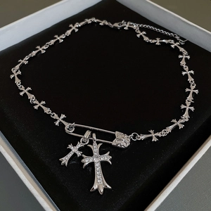 Detail of silver cross link necklace with pin clasp and zircon pendant in a gift box