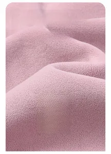 Macro shot of soft pink polar fleece fabric showing warmth and cozy texture