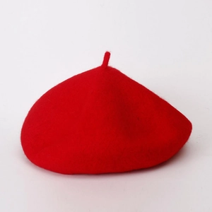 Detail of red wool beret texture and clean minimalist design on white background