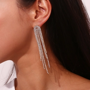 Close-up of dangling 18K gold plated tassels earrings with micro-set zircon stones