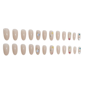 Summer almond press-on nails in nude pink with colorful rhinestone and heart gem accents