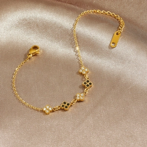 Elegant gold plated clover bracelet with black stones and sparkling diamond pavé accents