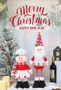Detail of Christmas chef dolls with plush heart and gingerbread decorations in a warm setting