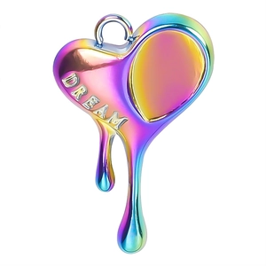 Macro detail of rainbow heart pendant with melting design and DREAM engraving