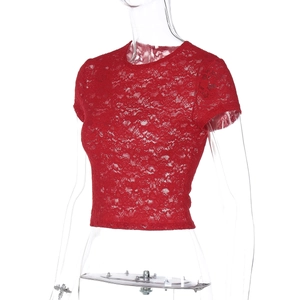 Gros plan sur la dentelle rouge ajourée d'un crop top ajusté à manches courtes