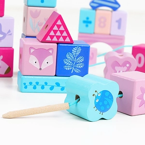 Macro detail of wooden educational beads with numbers, animals, and threading needle