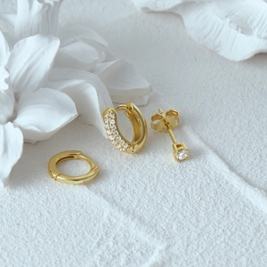 Detail of S925 sterling silver evil eye earring set with gold finish and small diamonds