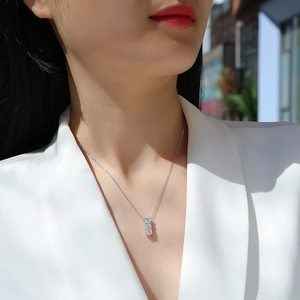 Elegant S925 sterling silver necklace with three vertical moissanite stones on a model
