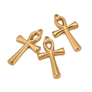 Detailed view of three polished gold Ankh cross pendants with smooth metallic finish