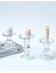 Close-up of three vintage Roman column glass candle holders with iridescent rainbow coating