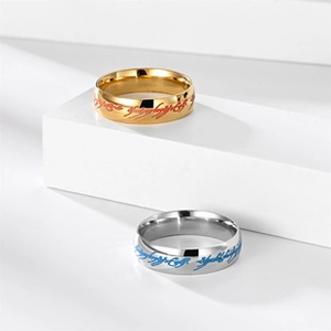 Close-up of polished stainless steel rings with Lord of the Rings inspired Elvish engraving