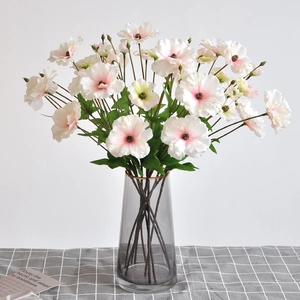 Artificial white Persian Buttercup with pink gradient in a gray gold-rimmed glass vase