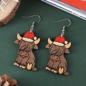 Christmas highland cow earrings with festive red hats on a textured green background