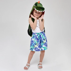 Toddler girl wearing a green 3D dinosaur plush backpack with hood and cute white teeth