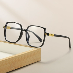 Classic black square oversized frames with gold chain metal accent on light wood tray