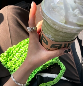 Irregular textured wave ring and twisted rope bracelet worn in a casual lifestyle setting