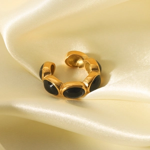 Detail eines 18K vergoldeten Rings mit schwarzen Inlays auf gelber Seide