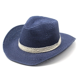 Detail of navy blue straw jazz hat featuring intricate weave and white lace ribbon band