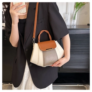 Detail of color-block crossbody bag with adjustable strap and Fashion & Bags text logo