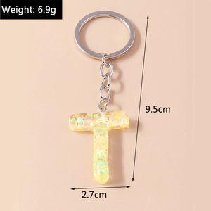 Detail of yellow glitter letter T keychain showing 9.5cm length and 6.9g weight specs