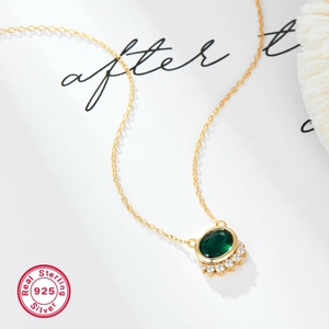 925 sterling silver necklace featuring an oval green zircon pendant on a gold chain
