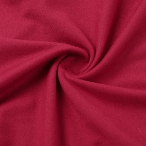 Detail of dark red elastic knit fabric with elegant spiral pleated texture and soft finish