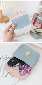 Detailed view of mini leather coin purse with golden metal buckle and interior card storage