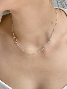 Minimalist 925 sterling silver chain necklace with golden clasp detail on model