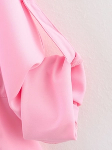 Detail of pink woven fabric with double stitching on safari style casual two-piece set
