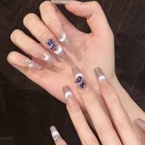 Lavender cat eye press-on nails with purple crystal rhinestones in long coffin shape